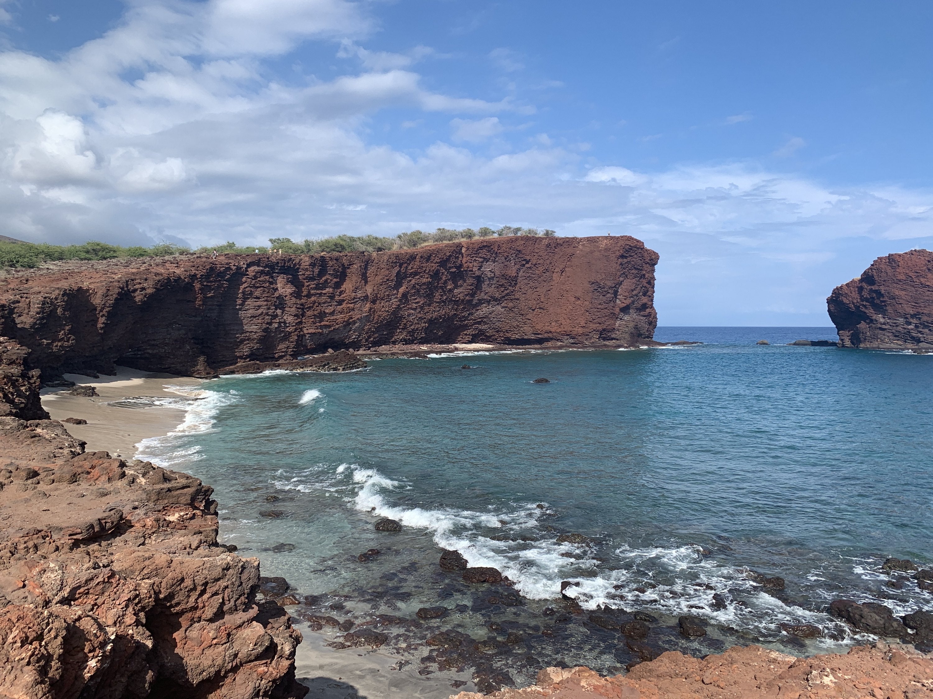 Red cliff and turquoise cove